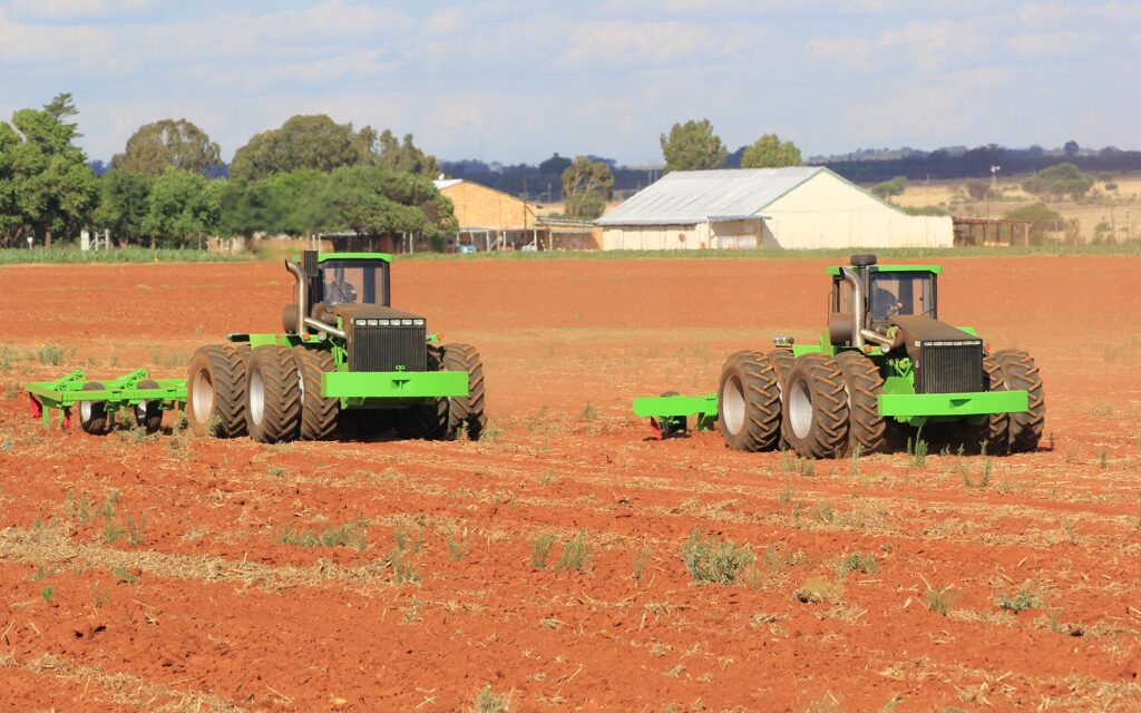 Two tractors ripping fields