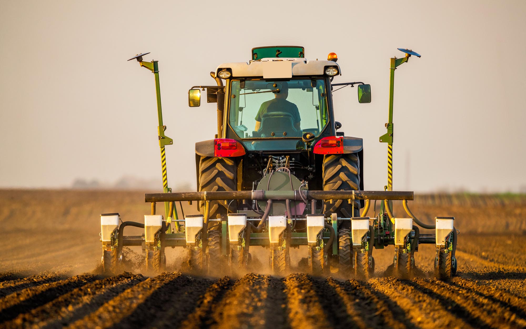 Tractor drilling seeding crops at farm. Agricultural activity.?