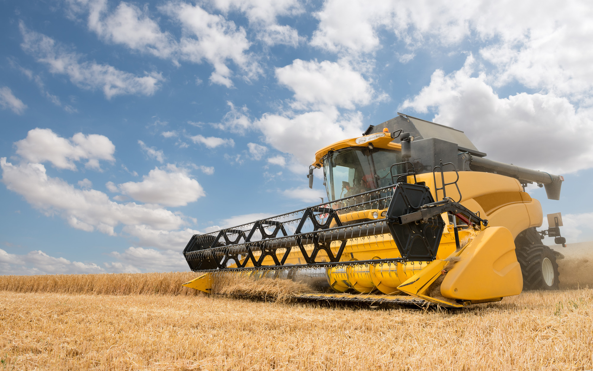 close view of modern combine harvester in action